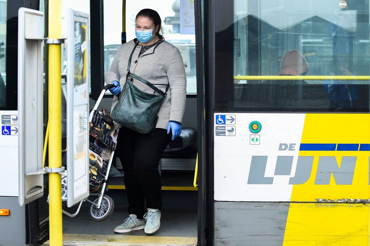 Een passagier met boodschappentas op een bus van De Lijn