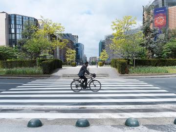 Een fietser op het verlaten Schumanplein in de Europese wijk