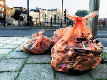 De oranje zakken met voedingsafval staan 's ochtends klaar om door Net Brussel opgehaald te worden